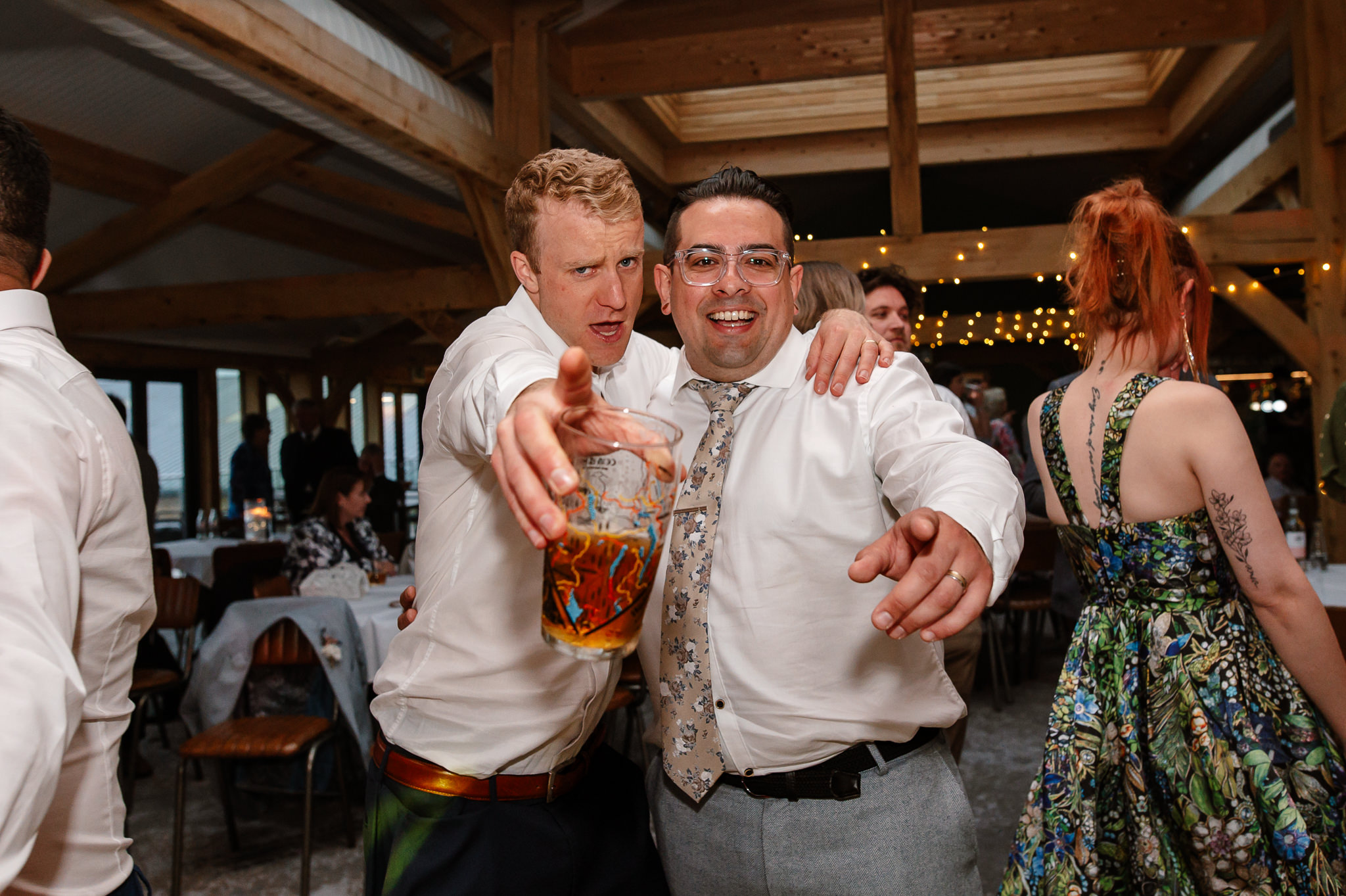 groom posing for a photo with a friend 