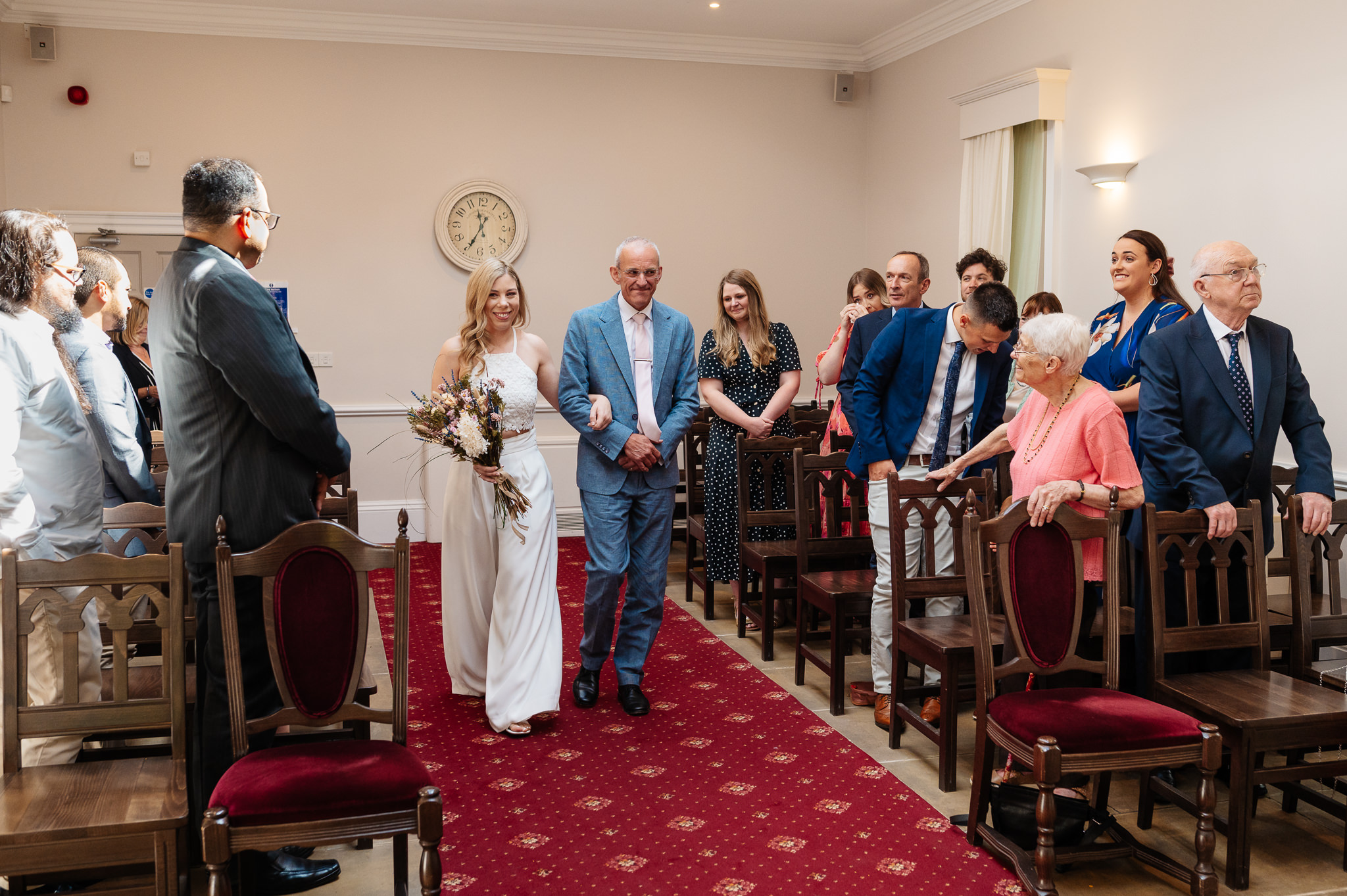 bride walking down the aisle with her father at york registry office 