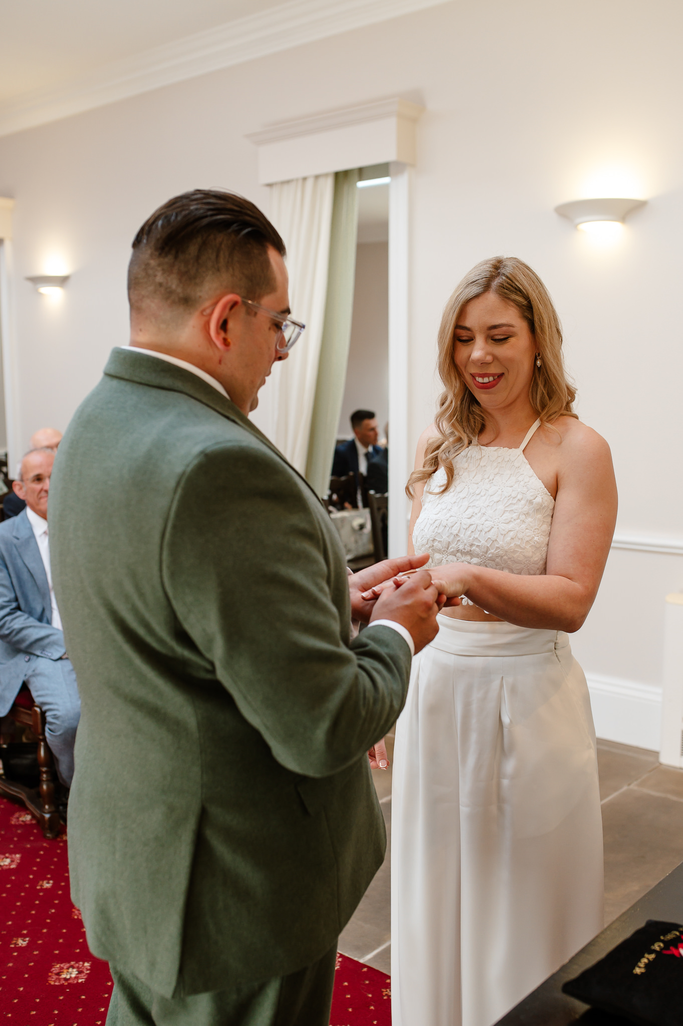 groom putting the ring on the brides hand during the ceremony at york registry office 
