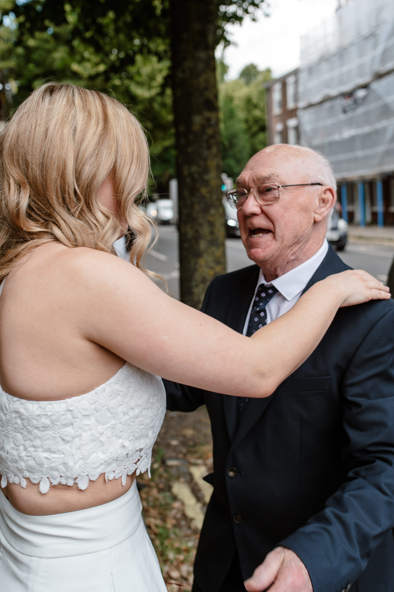 bride greeting her grandad as he arrives outside of york registry office 
