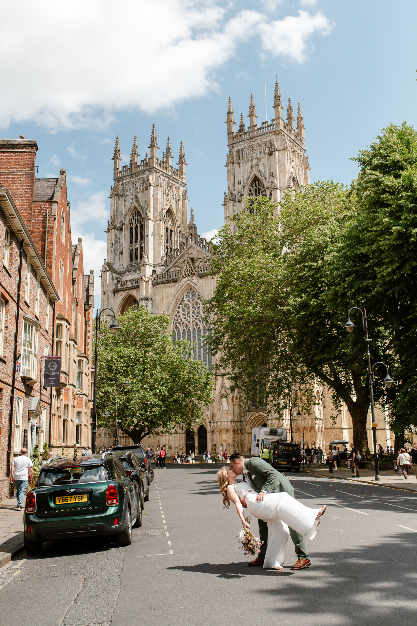 bride and groom drop kiss in front of york minster 