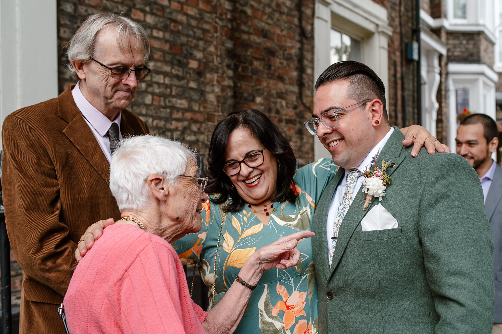 groom and family laughing before the ceremony outside of york registry office 