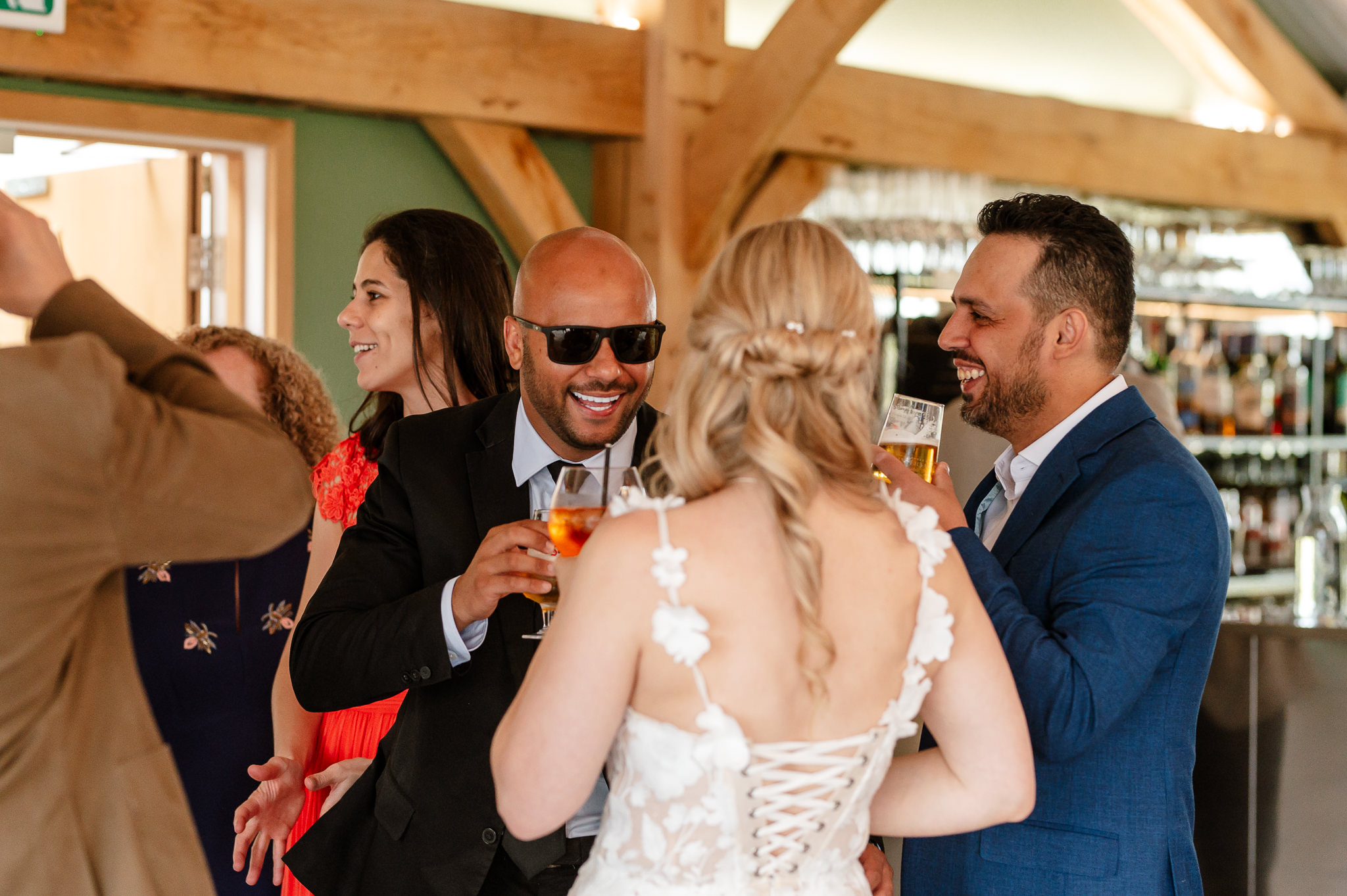 candid shot of guest talking to the bride 