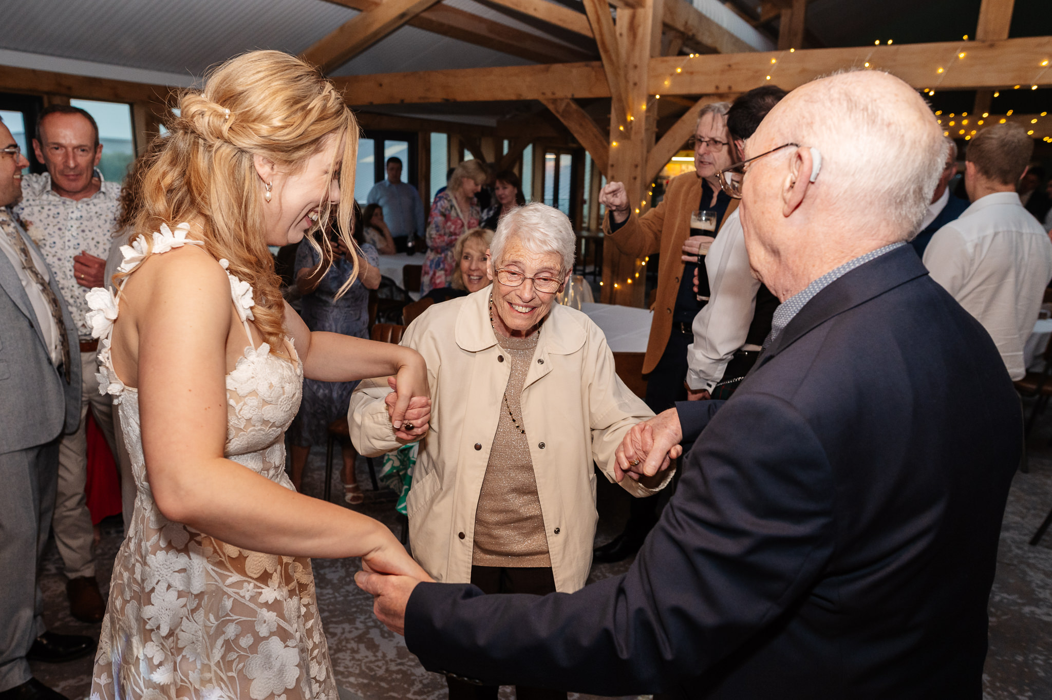 bride dancing with her grandparents at wedding reception