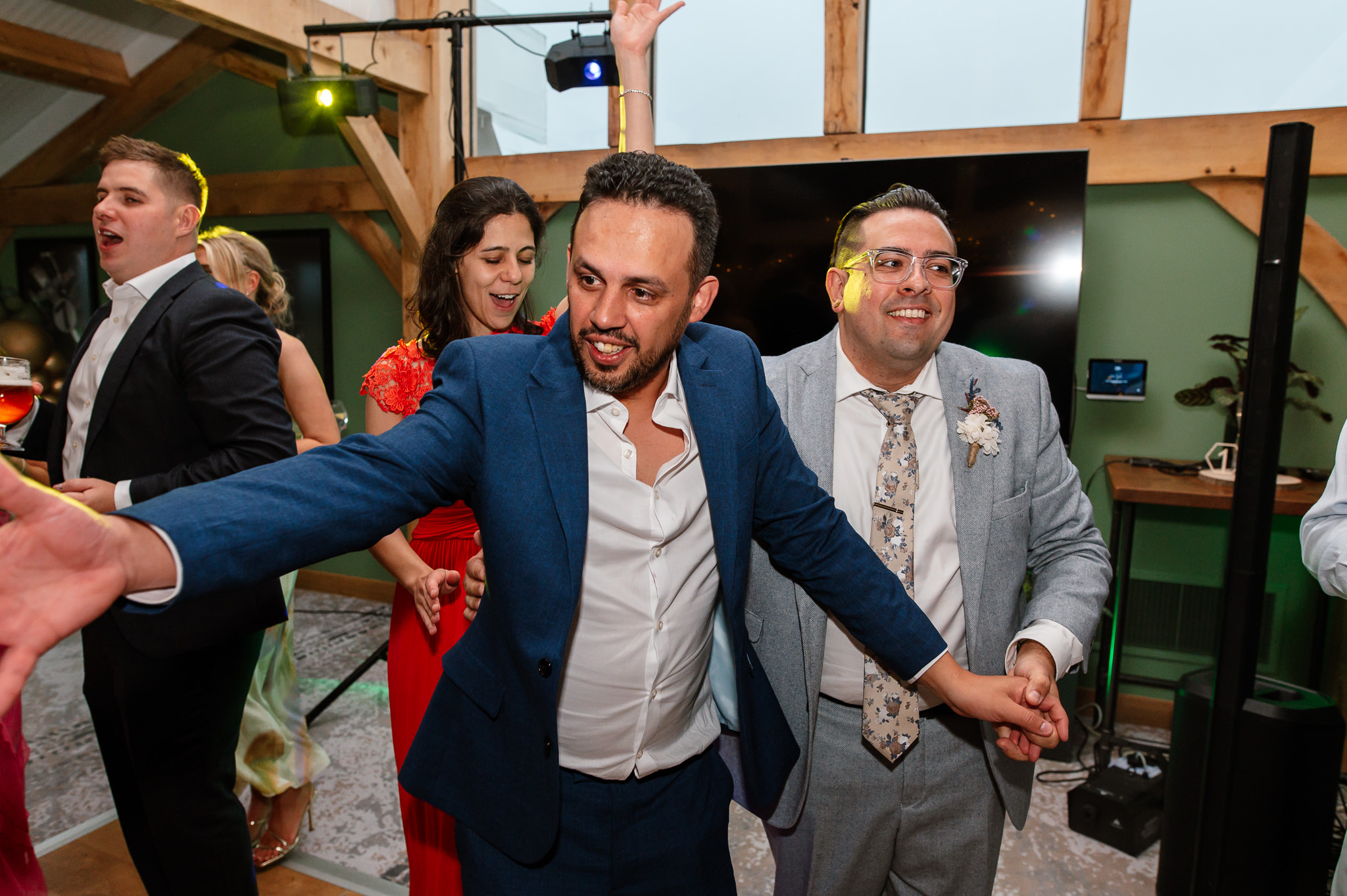 groom dancing with guest on dancefloor 